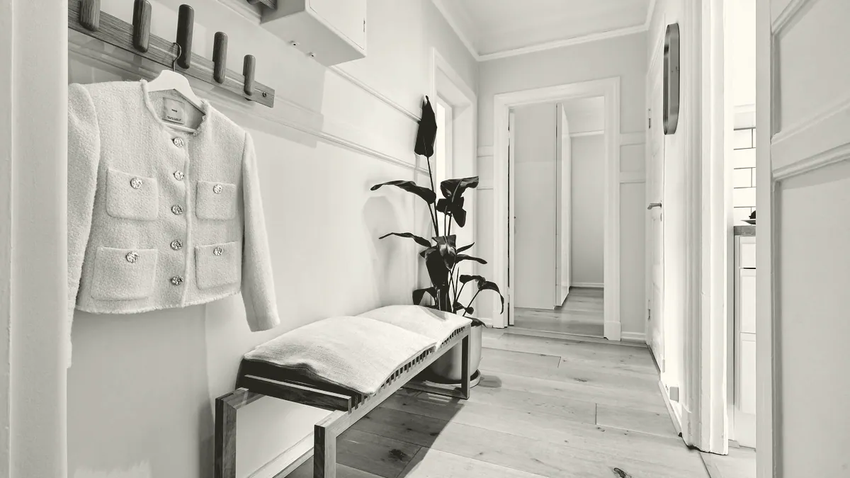 A coat on a hook in a hallway.