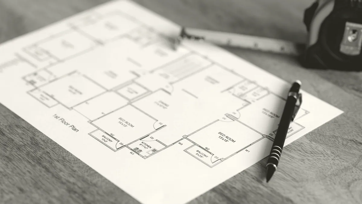 Plans spread out on a table.