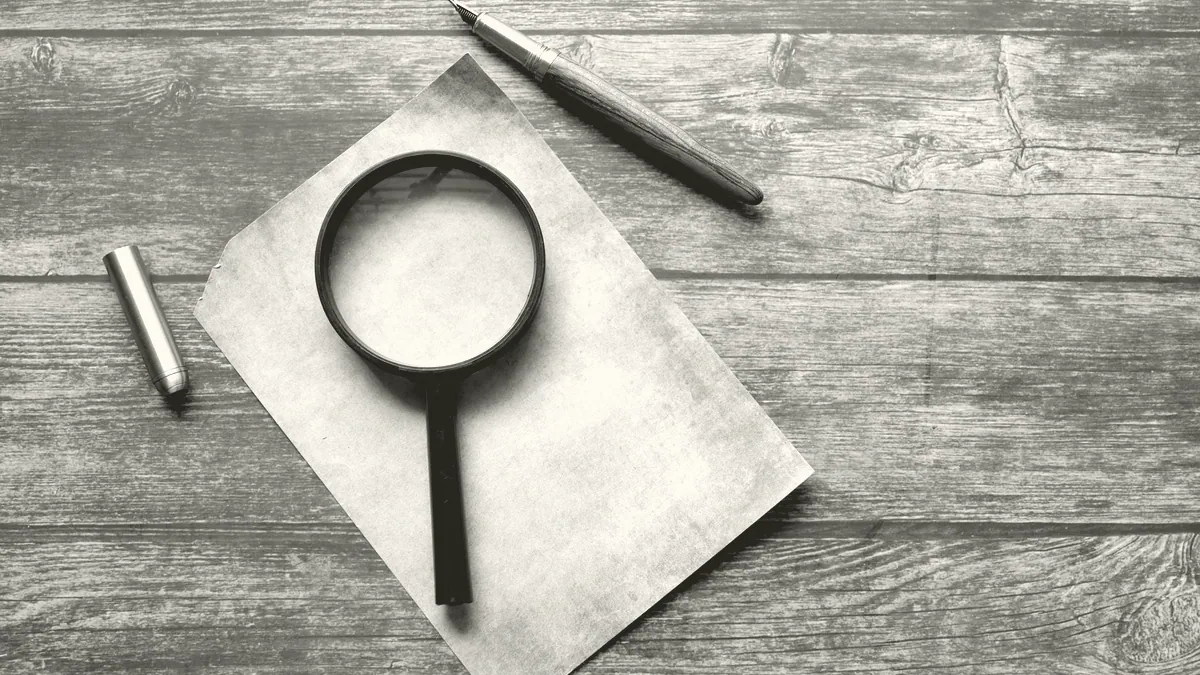 A magnifying glass on a page.