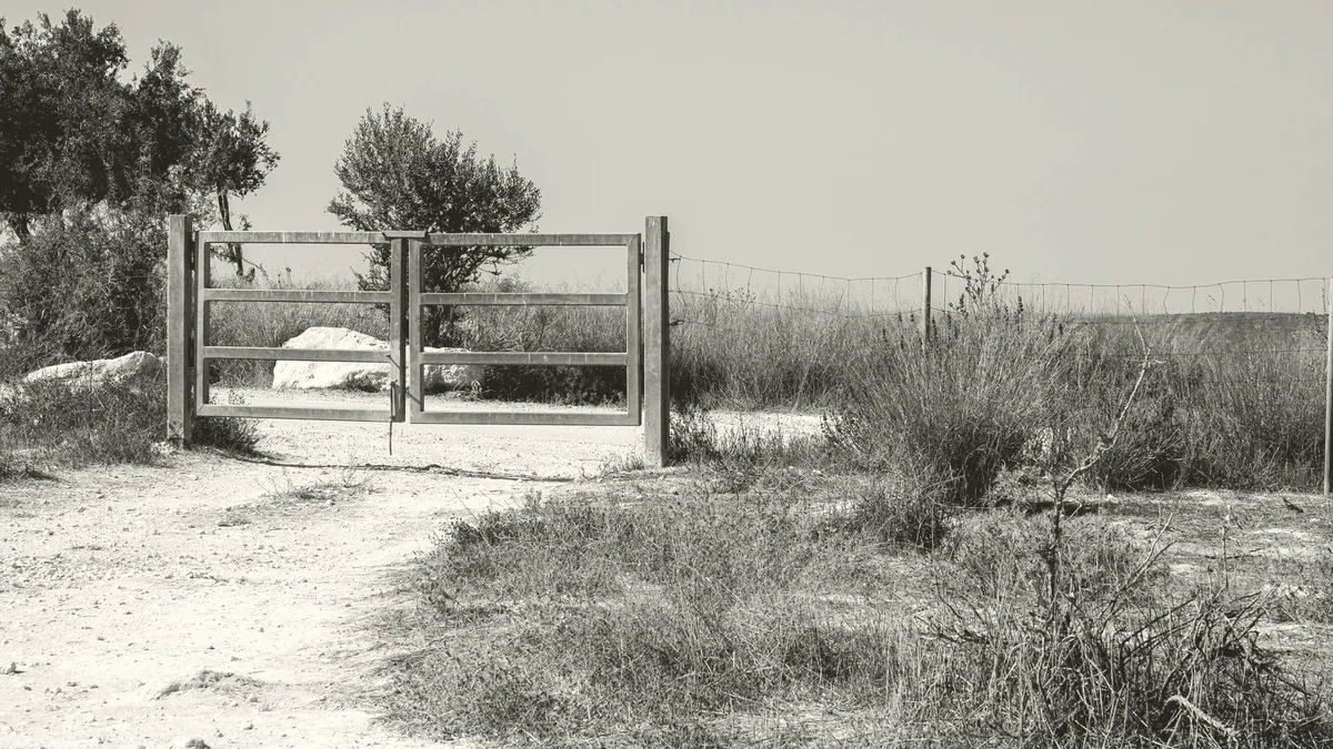 An open gate on a path.