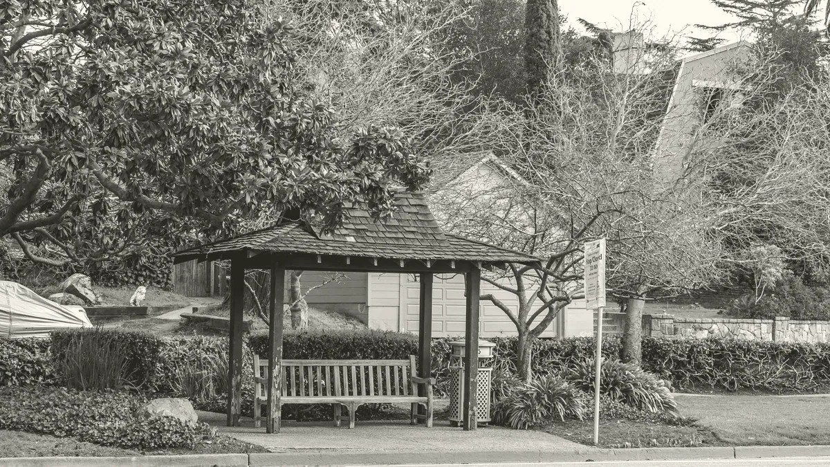 A bus stop on a suburban street.