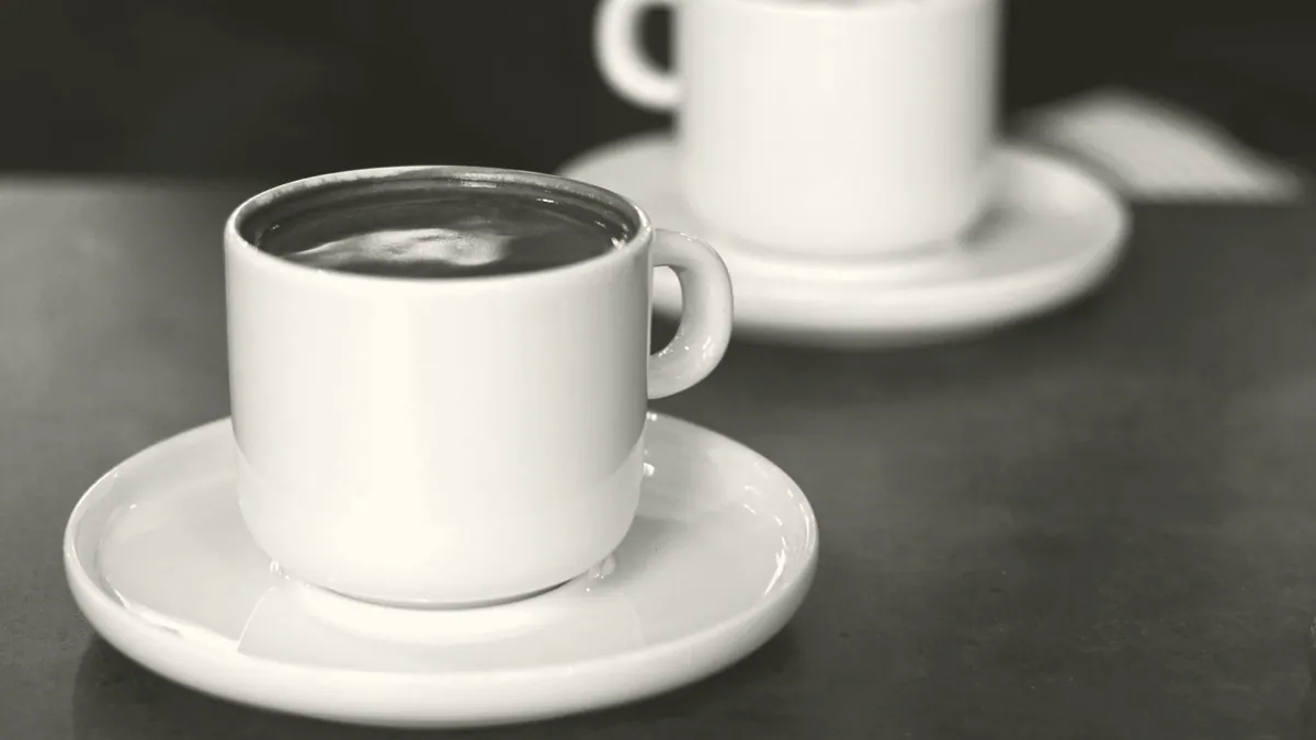 Two cups on a cafe table.