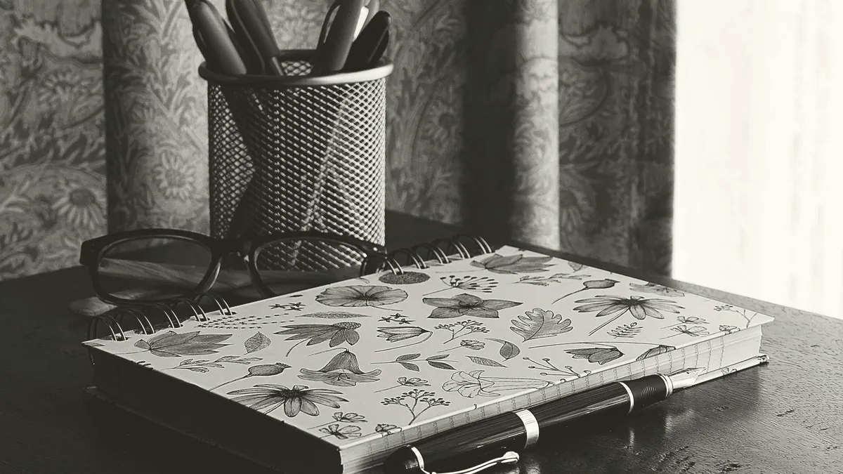 A notebook and pen on a desk.