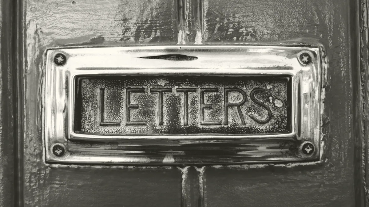 An envelope on a doormat.