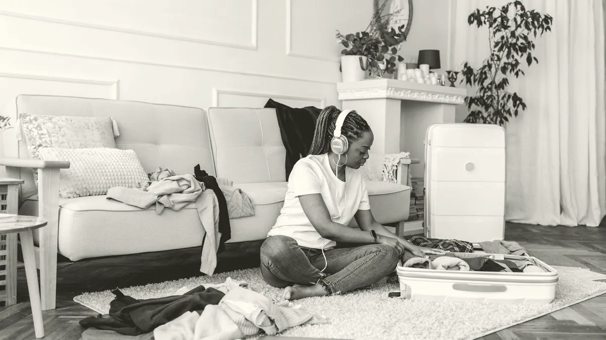A packed suitcase on the floor of a room.