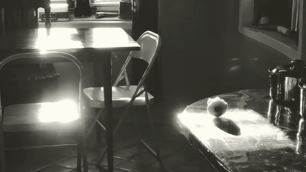 A kitchen table with two chairs.