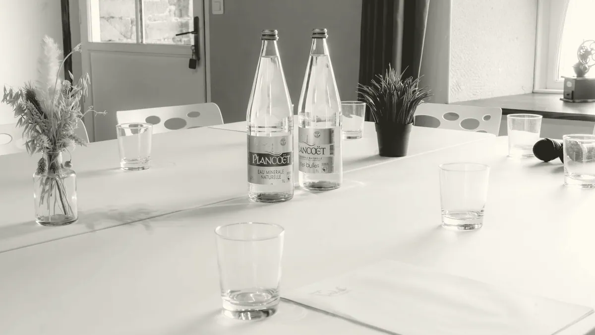 An empty glass-walled meeting room.
